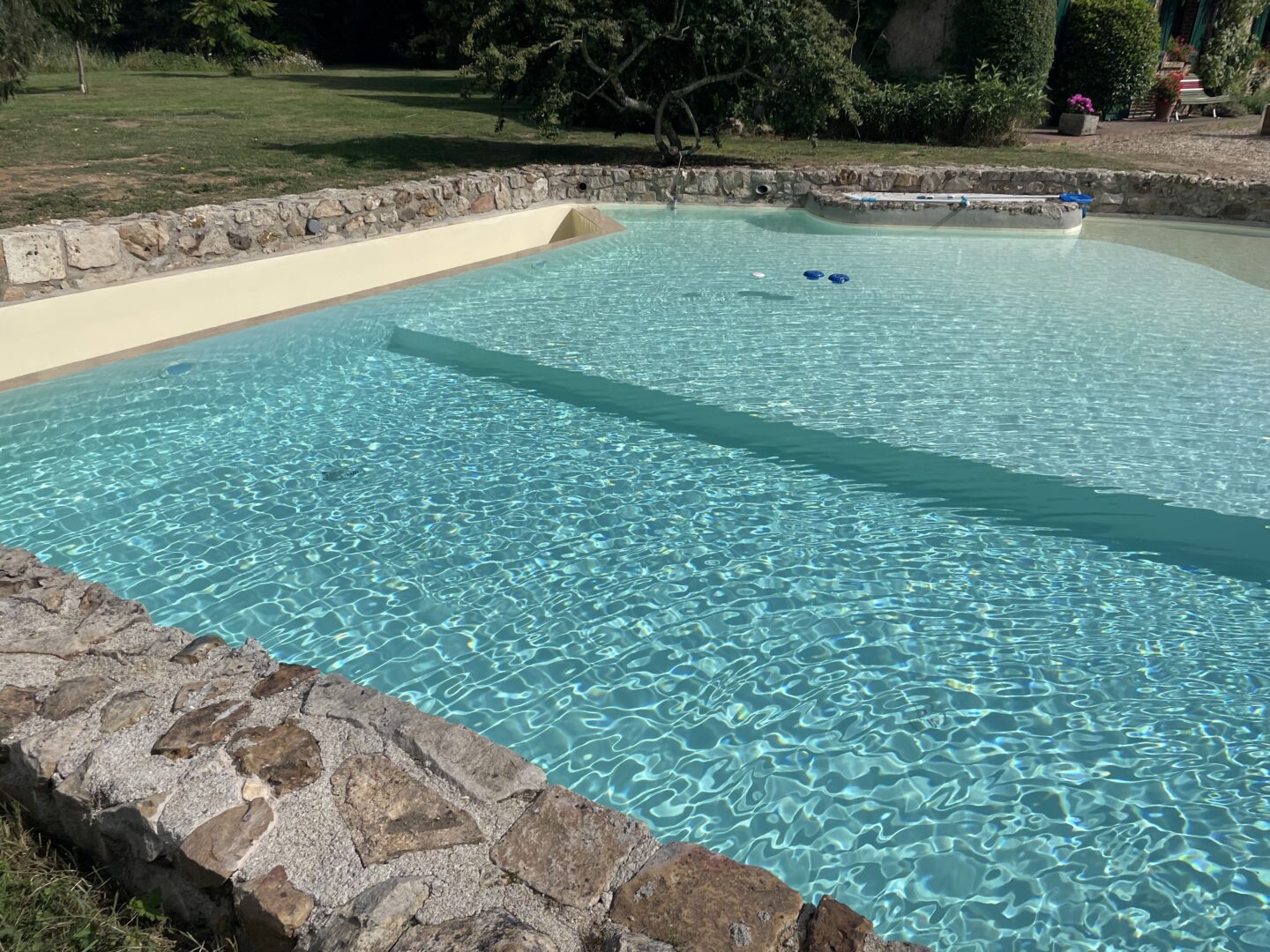 piscine enterrée rénovée par MA45 après rénovation complète du chantier et mise en eau du bassin